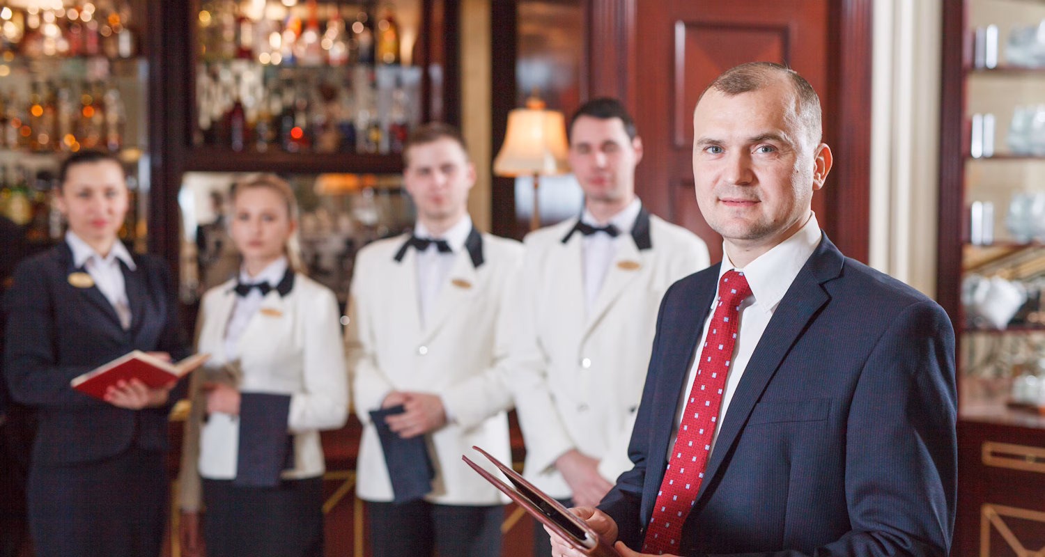 Image showing a hotel manager with staff in the background.