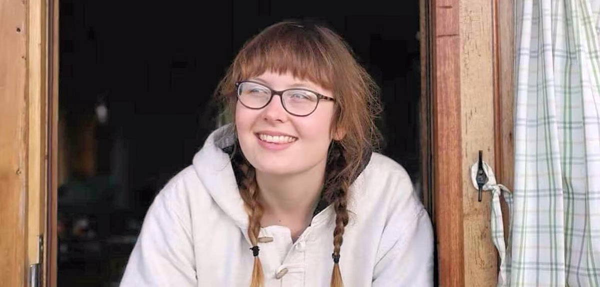 Image of Allie Mason leaning on a door