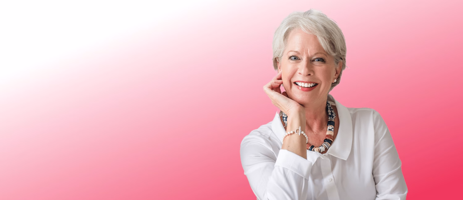 Image of Susie Mackie sitting in a relaxed pose and smiling at the camera