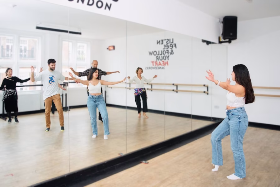 Image shows Amal Ishtar leading a dance class